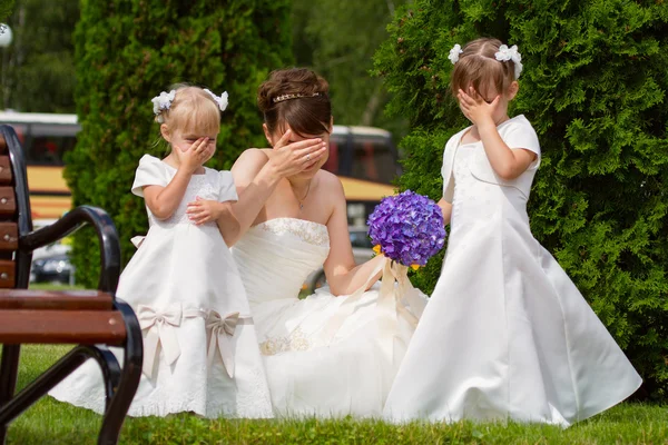 Bride stand with little girls in elegant dresses Stock Image