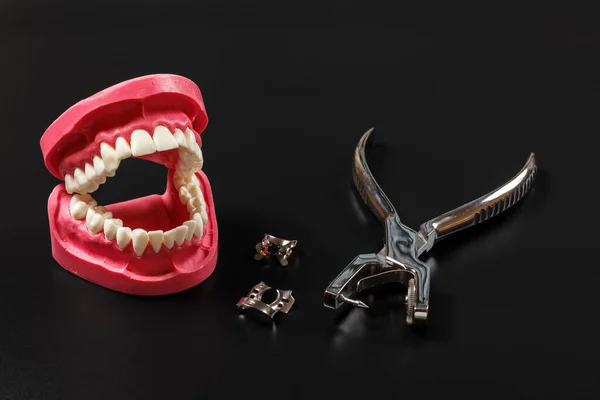Layout Human Jaw Dental Hole Punch Clamps Black Background Medical — Stock Photo, Image