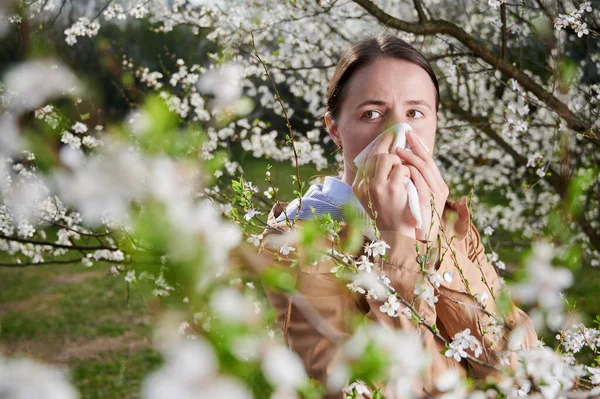 Woman allergic suffering from seasonal allergy at spring.