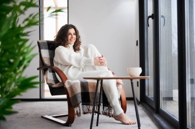 Young woman enjoying weekends inside modern barn house.