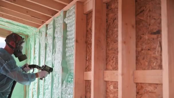 Male Builder Insulating Wooden Frame House Man Worker Spraying Polyurethane — 비디오