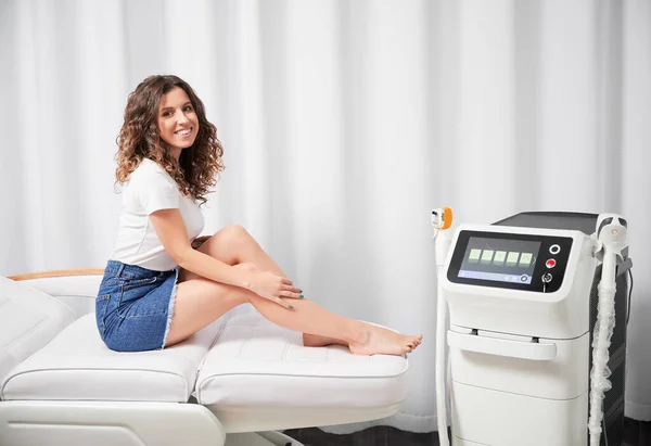 Cheerful Young Woman Smiling Camera Sitting Daybed Diode Laser Epilation — Foto Stock