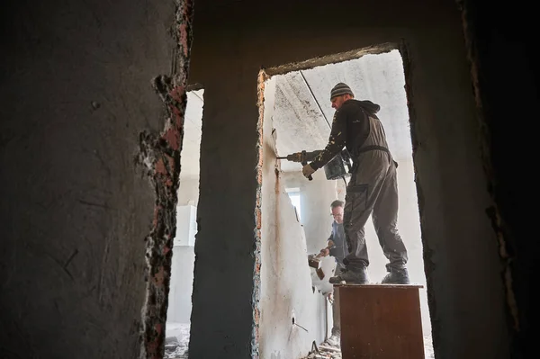 Bottom View Two Builders Deconstructing Interior Partition One Worker Standing — Stock Photo, Image