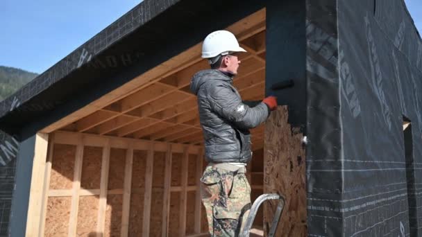 Male Painter Using Paint Roller Doing Exterior Paint Work Black — Vídeos de Stock