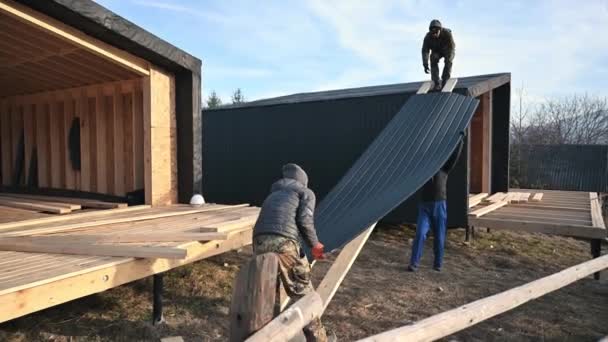 Male Builders Installing Black Corrugated Iron Sheet Used Facade Future — Αρχείο Βίντεο