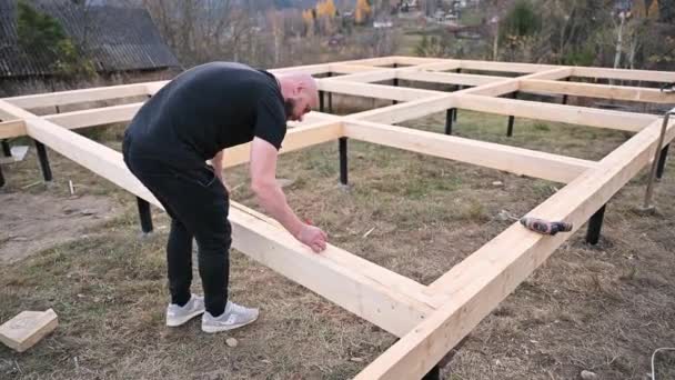 Man Worker Building Wooden Frame House Pile Foundation Carpenter Using — Stockvideo