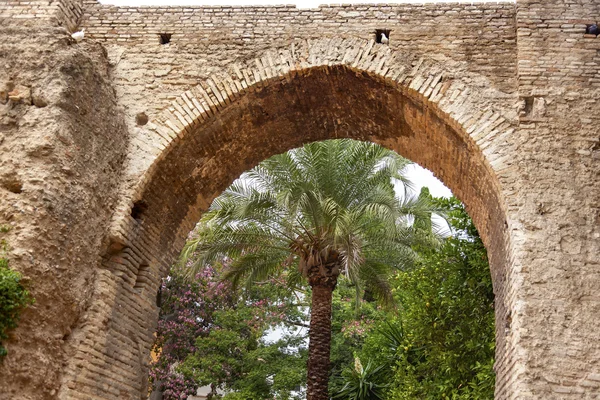 Kő boltív kerti alcazar royal palace Sevillában Spanyolország — Stock Fotó