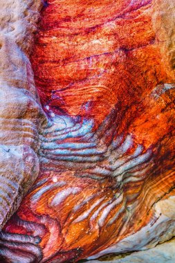 Red Blue Orange Rock Abstract Petra Jordan Built by  Nabataens in 200 BC to 400 AD Canyon walls create many colorful abstracts close up Reds from magnesium in sandstone.