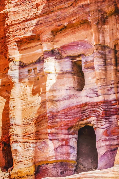 Colorful Red Blue Rock Tomb Petra Jordan Built by Nabataens in 200 BC to 400 AD. Canyon walls create many abstracts close up.