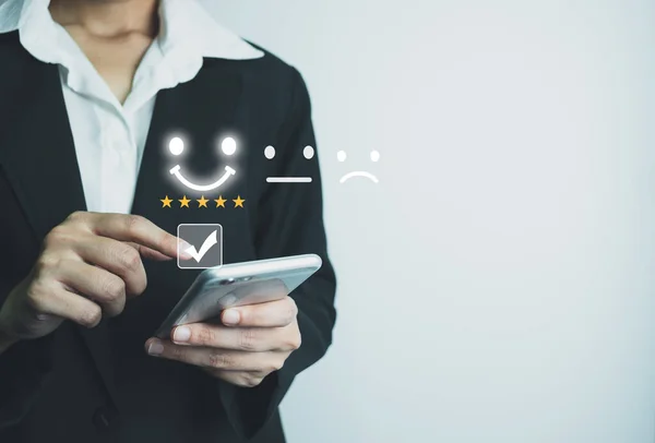 Businesswoman assess service satisfaction 5 stars by smartphone, Corporate care high standard, ISO, customer care, Excellent level, quality guaranteed in service of company. the highest service.
