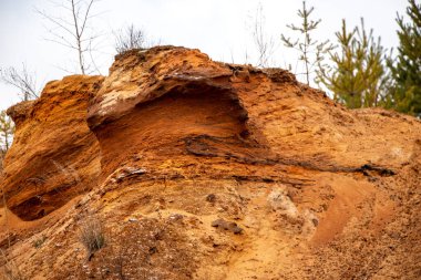 Doku kumu, kabartma yüzeyi, çok renkli katmanlar ve granül büyüklüğünde farklılık, açık hava kum kariyerinde, maden cevheri ve inşaat için kum çıkardıktan sonra. 
