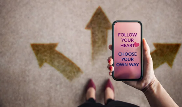 Follow Your Heart Concept. Woman Using Mobile Phone to Choose her Own Way. Many Direction Arrow on the Floor. Decision in Life or Business. Top Vie