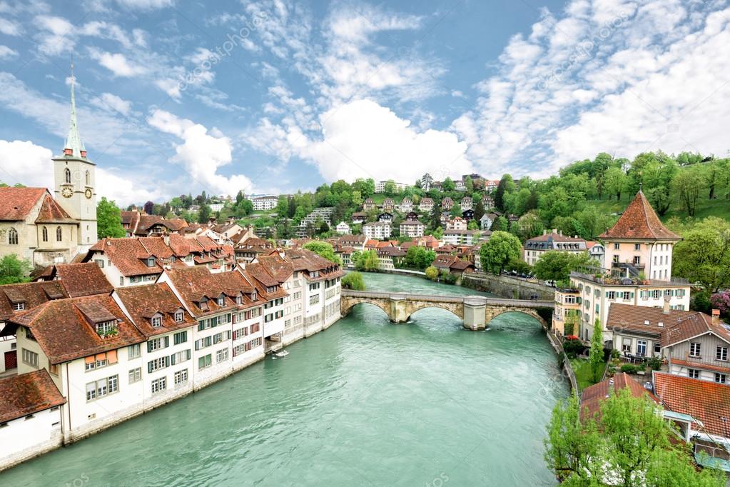 Church, bridge and houses with tiled rooftops, Bern, Switzerland