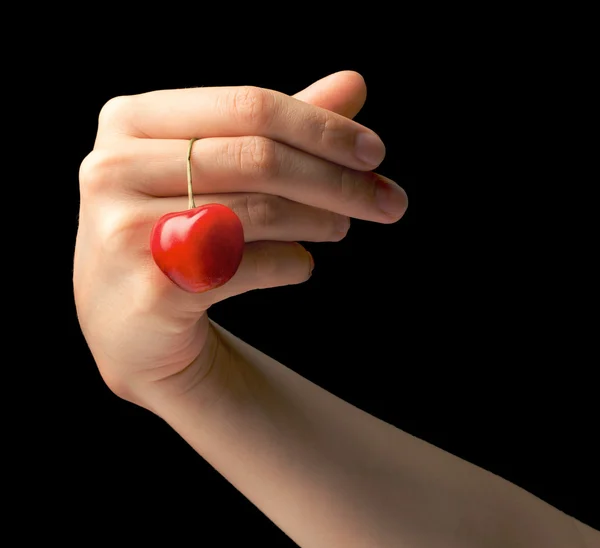 Sweet cherry in a hand at the girl — Stock Photo, Image