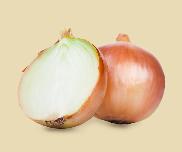 Onions cut in half on a yellow background. — Stock Photo, Image