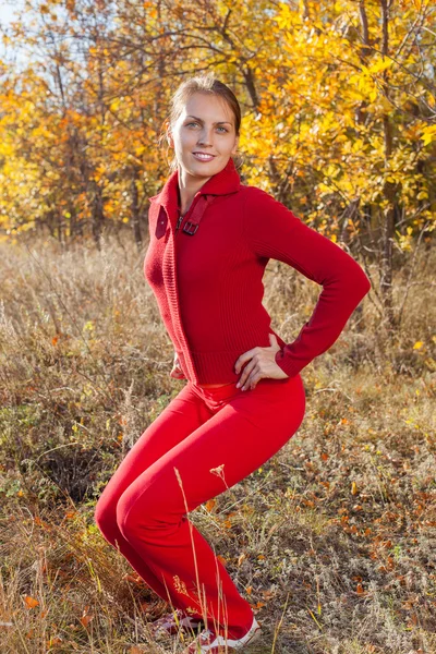 Young woman stretching before her run outdoors on a cold fall, winter day — Stock Photo, Image