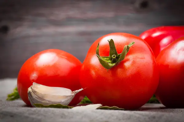 Fresh tomatoes on a background wooden boards — Stock Photo, Image