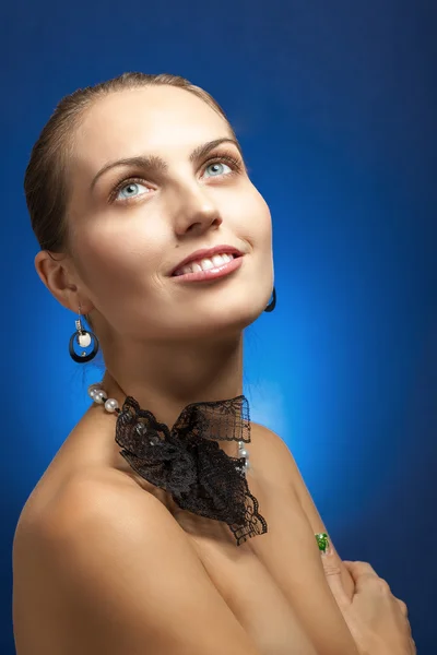 Portrait of beautiful girl on blue background — Stock Photo, Image