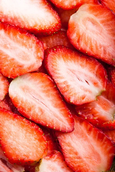 Plátky strawberris jako pozadí — Stock fotografie