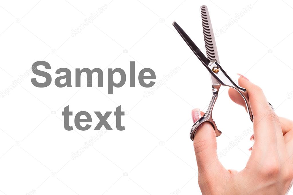 Scissors in hand isolated on white