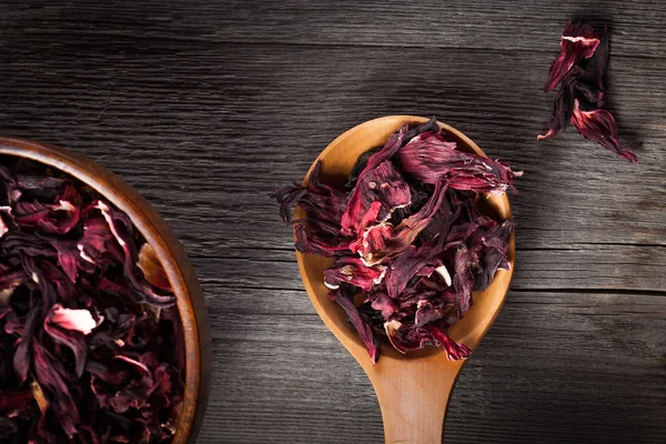 Bowl of aromatic Hibiscus tea with wooden spoon — Stock Photo, Image