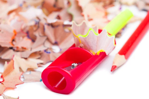 Colored pencil shavings and sharpener — Stock Photo, Image