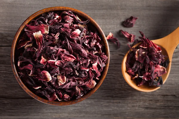 Bowl of aromatic Hibiscus tea with wooden spoon — Stock Photo, Image