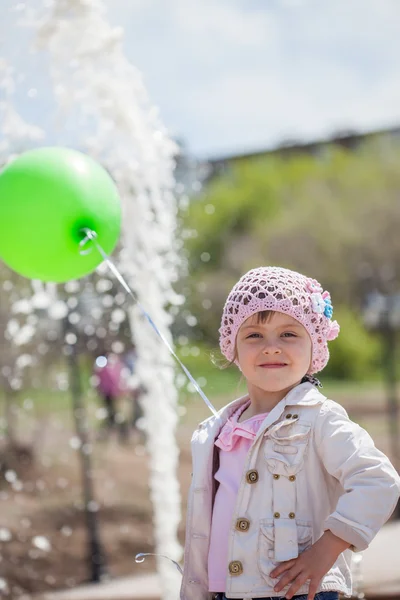 Little girl with green air balloon — Stock Photo, Image