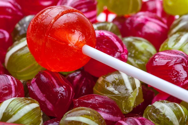 Lollipop on ball shaped candy — Stock Photo, Image