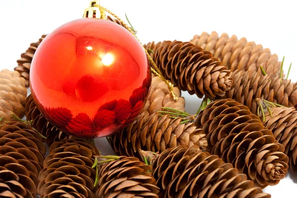 Festive bauble and pine cone — Stock Photo, Image