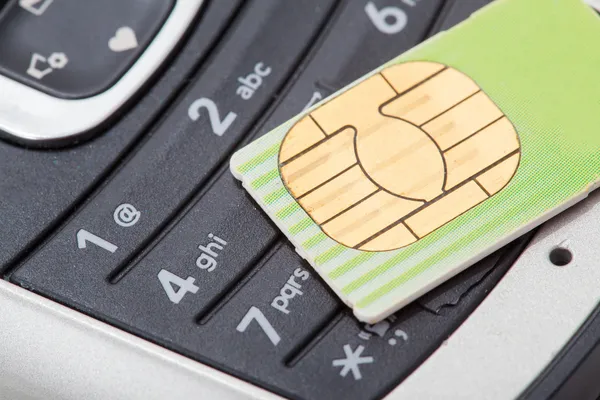 Cell phone and sim card — Stock Photo, Image