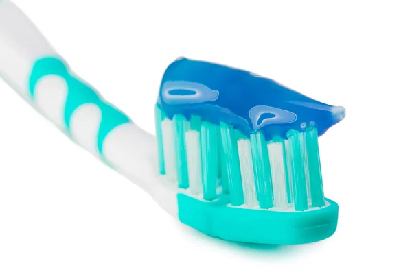 Pâte à dents serrée sur la brosse à dents — Photo