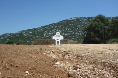 San Pietro church on Golgo upland with zoom on the street clipart