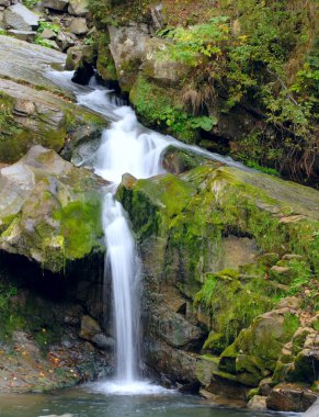 Autumn waterfall in Carpaty mountain