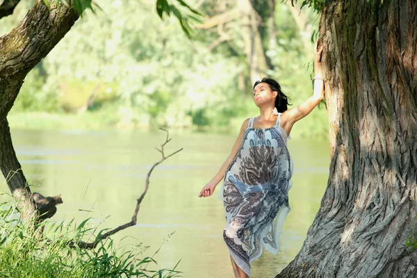 Nice woman near river — Stockfoto