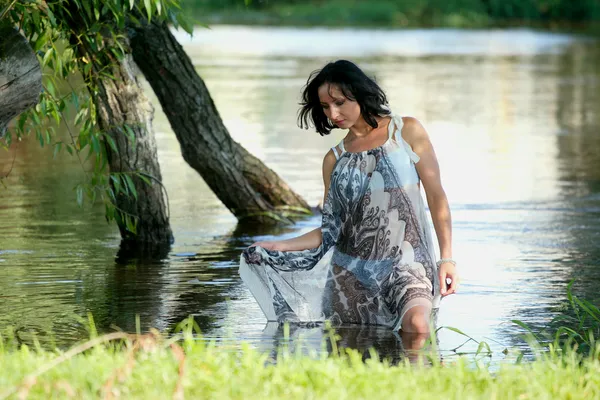 Nice woman near river — Stok fotoğraf