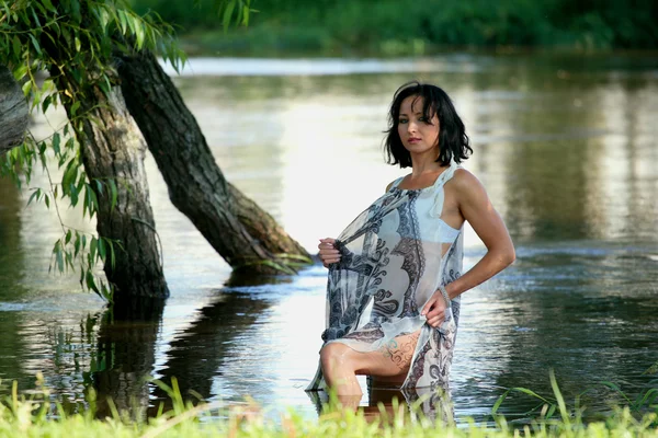 Nice woman near river — Stok fotoğraf