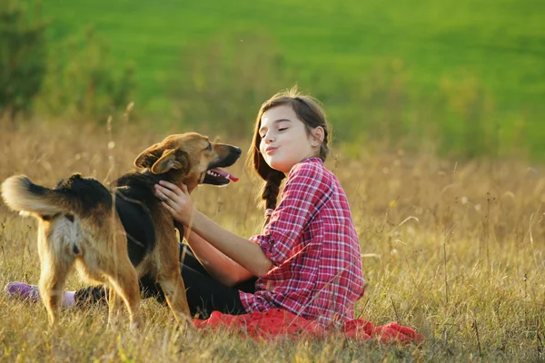 Teen flicka som leker med sin hund — Stockfoto