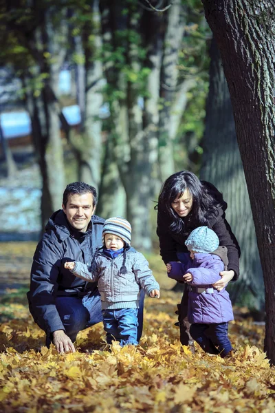 Family in the autumn park — Stock Photo, Image