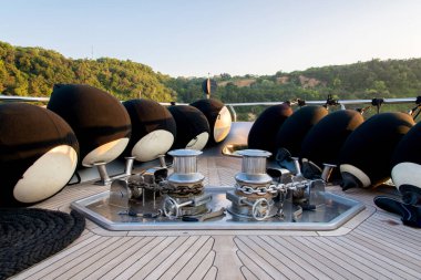 Anchor lowering and raising mechanism, Anchor Buoys and rigging on  the foredeck of a luxurious yacht - selective focus