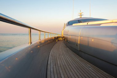 Beautiful sea view from the left board side of a luxury yacht at sunset / sunrise - horizontal orientation