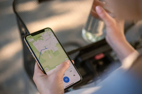 girl cyclist looks at a map on her phone and plots a route for a trip for a GPS navigator. High quality photo