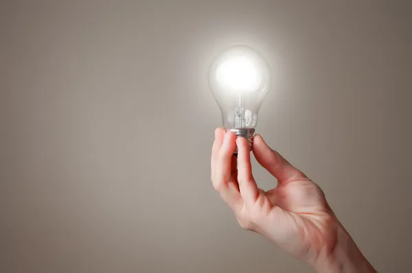 Hand with light bulb — Stock Photo, Image