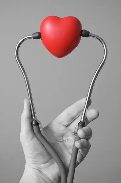 Mano con stetoscopio e un cuore — Foto Stock