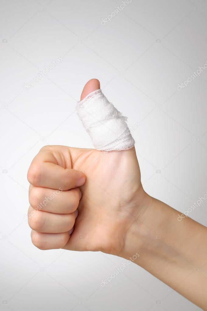 Injured thumb with bandage