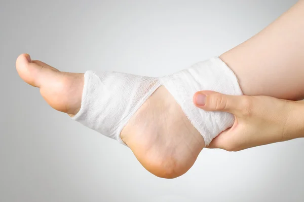 Injured foot with bandage — Stock Photo, Image