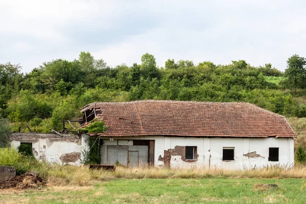 Panorama of an abandoned farm of Central Serbia in an agricultural landscape. The region of Balkans is hit by a severe rural exodus and emigration deserting the area