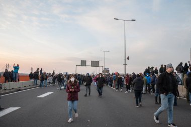 BELGRADE, SERBIA - DECEMBER 4, 2021: Young woman wearing a facemask during coronavirus covid 19 protesting against serbian government, rio tinto lithium mines & pollution in Serbia