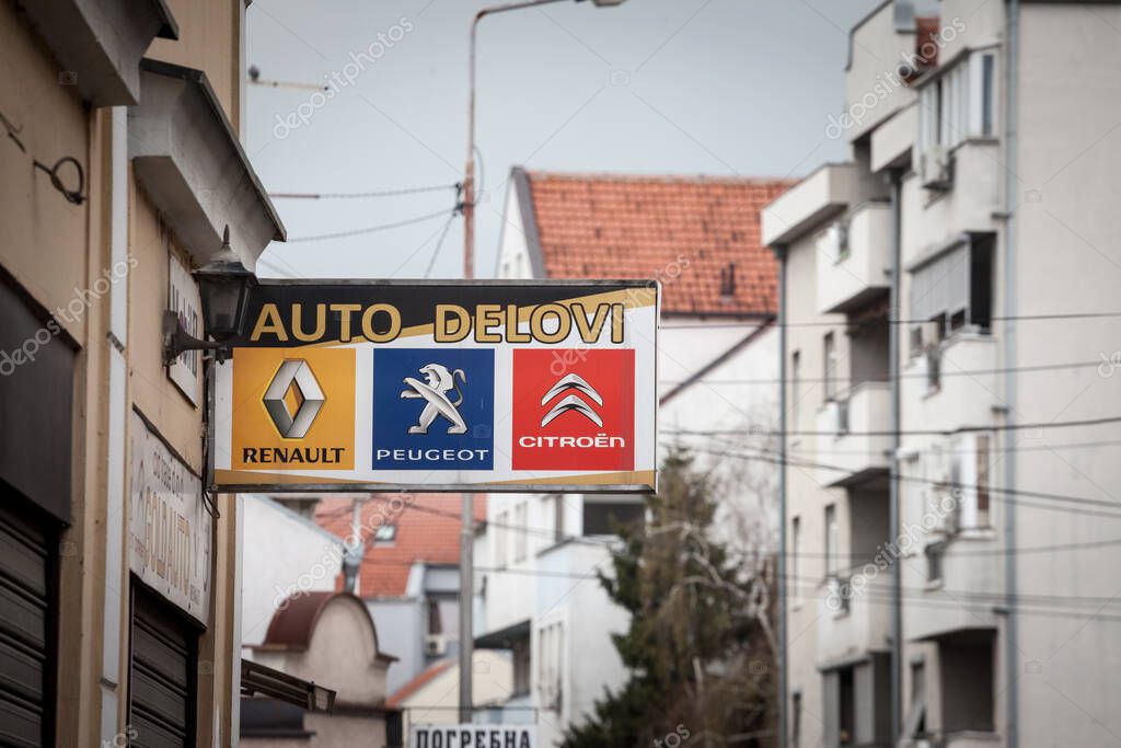 BELGRADE. SERBIA - APRIL 4, 2021: Renault Peugeot and Citroen logos on an sign of a car mechanic in Belgrade. These are the three main automotive and automobile manufacturers of France.