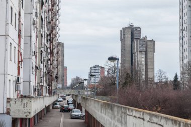 BELGRADE, SERBIA - FEBRUARY 5, 2022: High rise buildings from the district of Blok 61 in Novi Beograd, a traditional communist housing ensemble with a brutalist style clipart